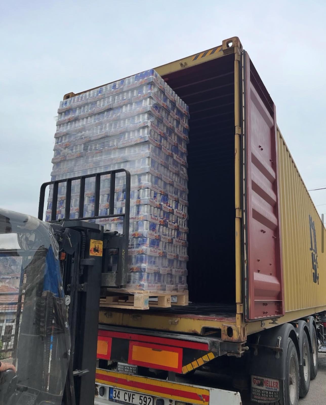 Energy drink pallets being loaded onto a freight truck