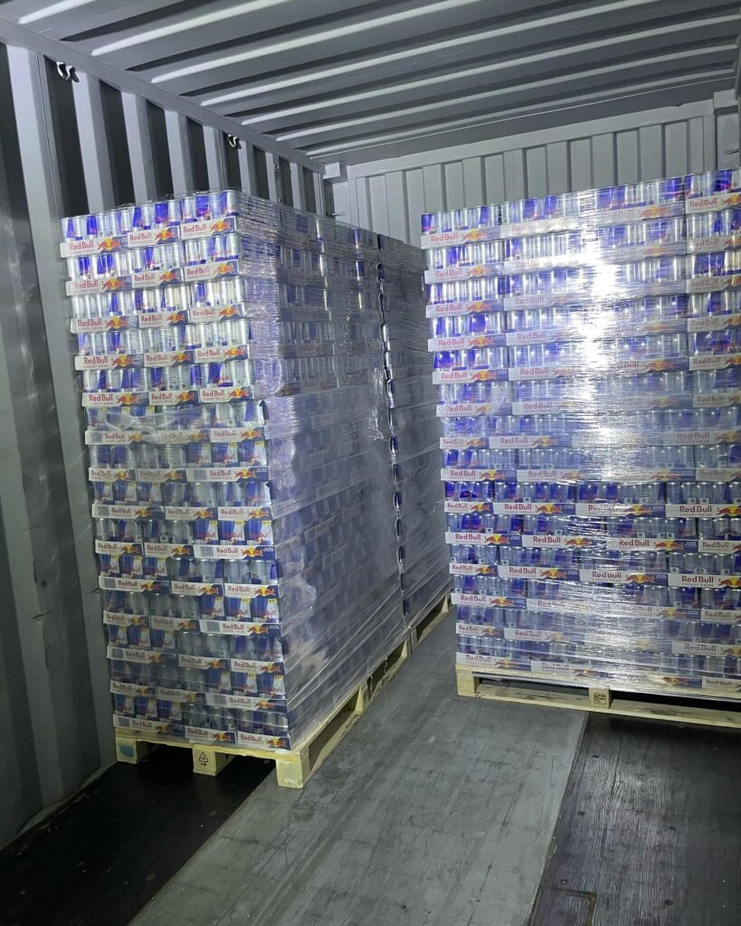 Shrink-wrapped wholesale energy drink pallets loaded for delivery to a convenience store