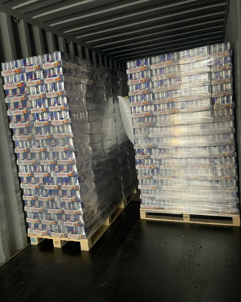 Wholesale energy drink pallets stacked and wrapped, ready to restock convenience store coolers