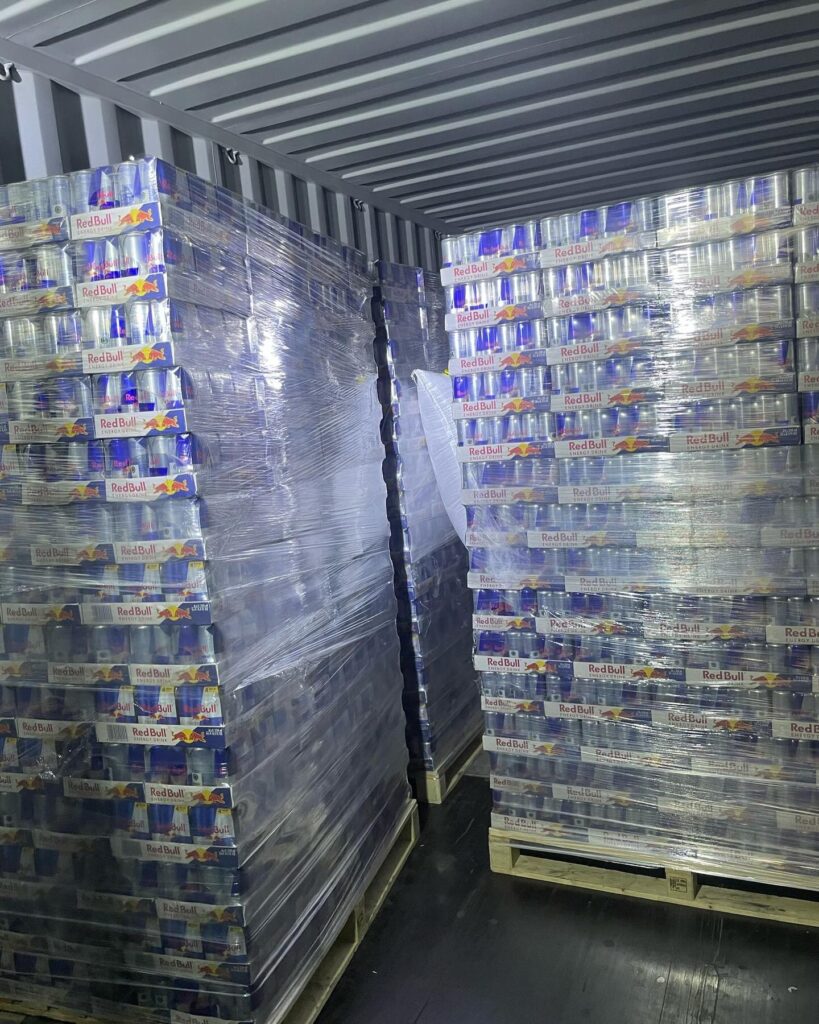 Stretch-wrapped wholesale energy drink pallets loaded for a supermarket distribution delivery